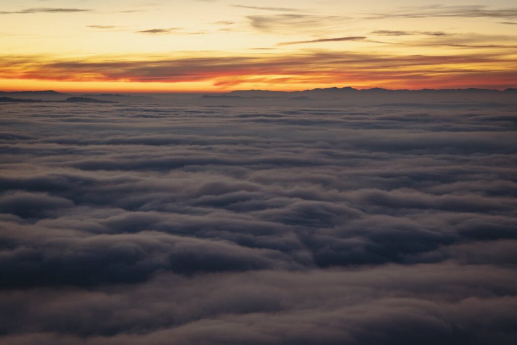 pexels photo 29442910 A breathtaking view of a vibrant sunset above a thick cloud layer, creating a serene atmosphere.